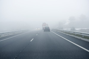 View of a highway covered in fog