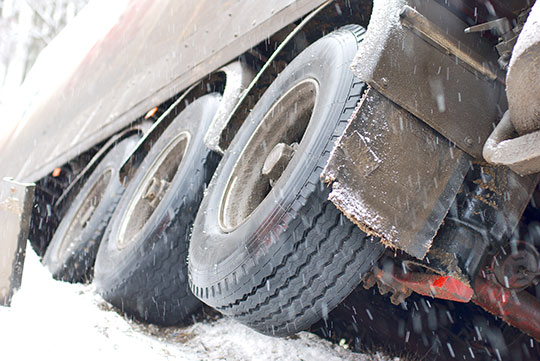 Truck tipped over on side of road in snowstorm