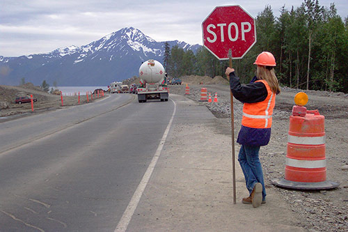 Flagger holding stop sign in construction zone