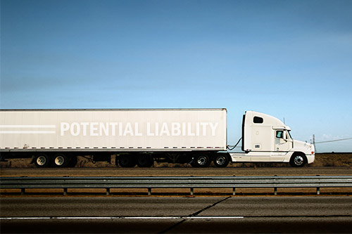 Semi truck with 'potential liability' written on the side
